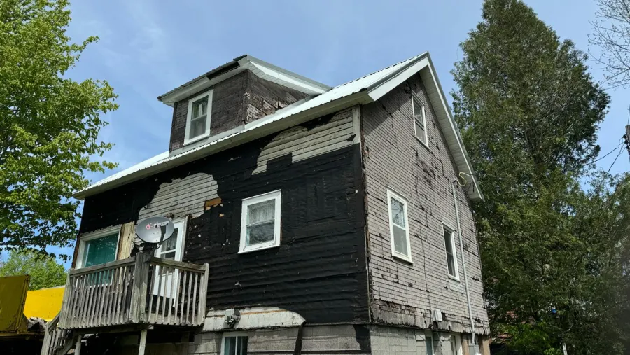 Before: deteriorated exterior siding