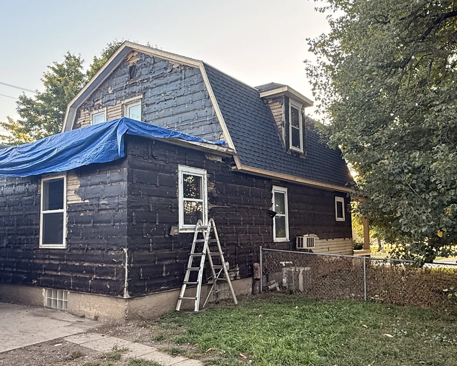 Before: worn or damaged siding before replacement