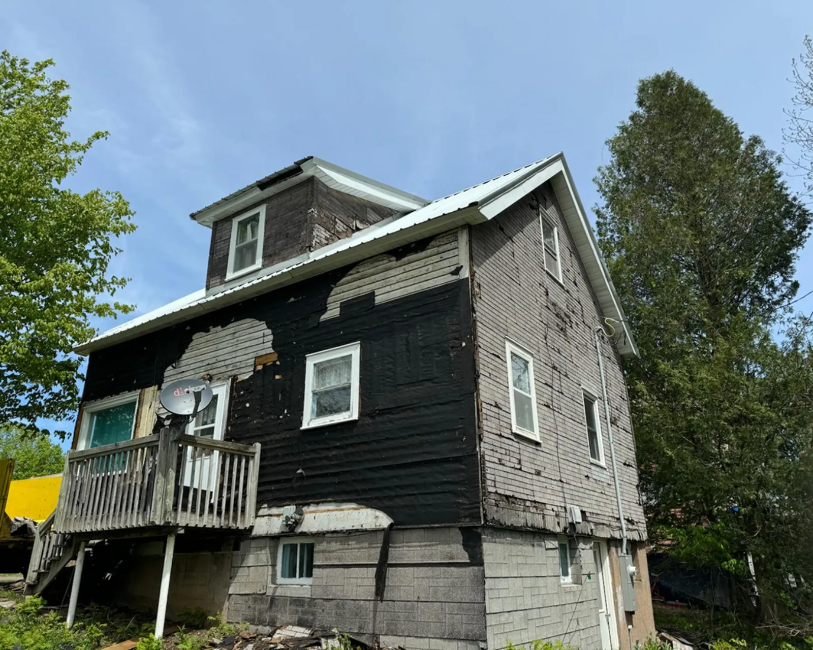 Before: worn or damaged siding before replacement